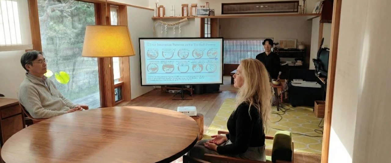 Participants and hosts in conversation around a table in Kamakura